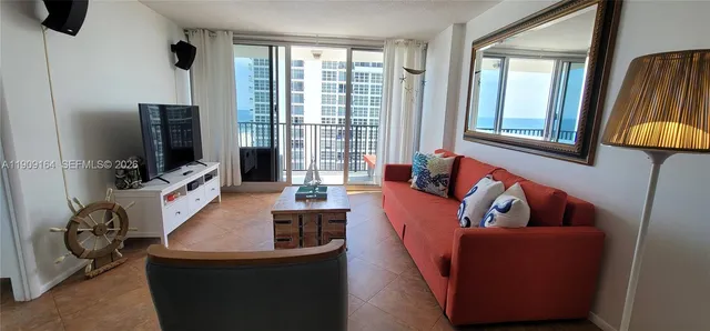 a living room with furniture and a flat screen tv