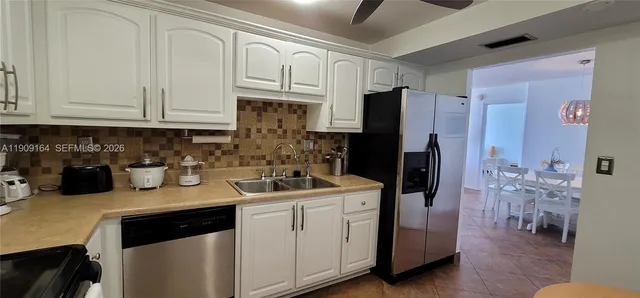 a kitchen with stainless steel appliances granite countertop a refrigerator and a stove