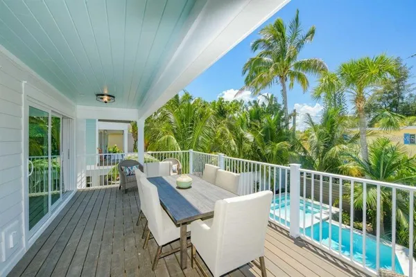 a view of a deck with furniture and garden