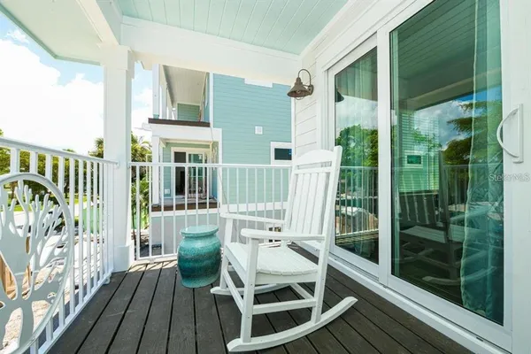 a balcony view with a large window and wooden floor