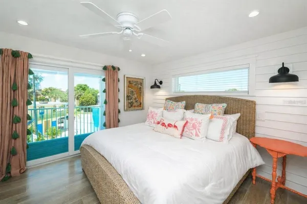 a bedroom with a large bed and a large window
