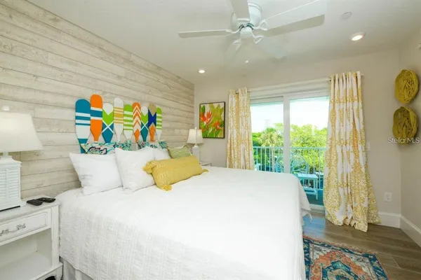 a bedroom with a bed and a large window