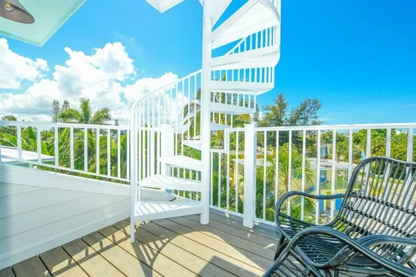 a view of a balcony with wooden floor