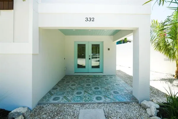 a view of a hallway with entryway and livingroom view