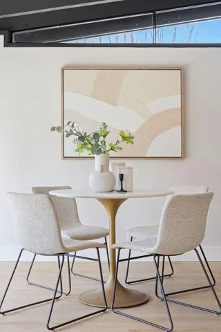 a dining room with furniture and wooden floor