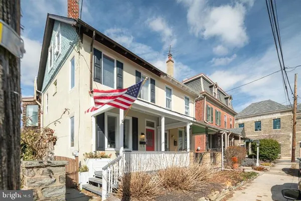 a front view of a residential apartment building with a yard