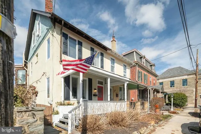 a front view of a residential apartment building with a yard