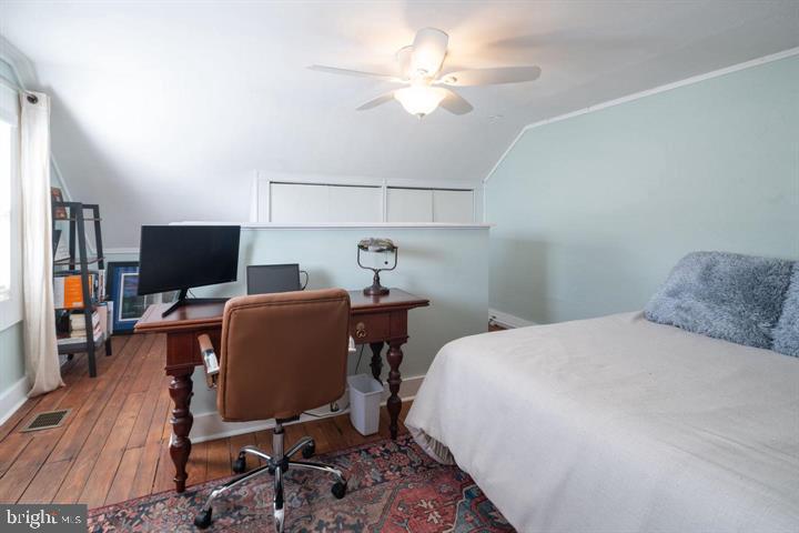 229 Benezet Street Philadelphia, PA 19118 - Photo 17 of 31 a bedroom with a bed and a flat screen tv