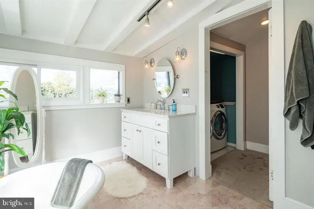 a view of a hallway with washer and dryer