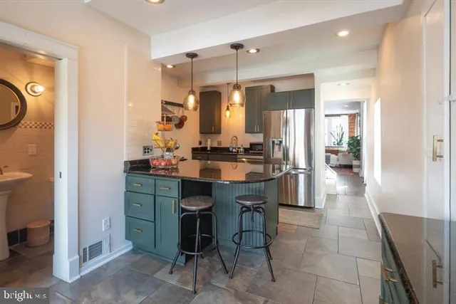 a bathroom with a sink a toilet a mirror and shower