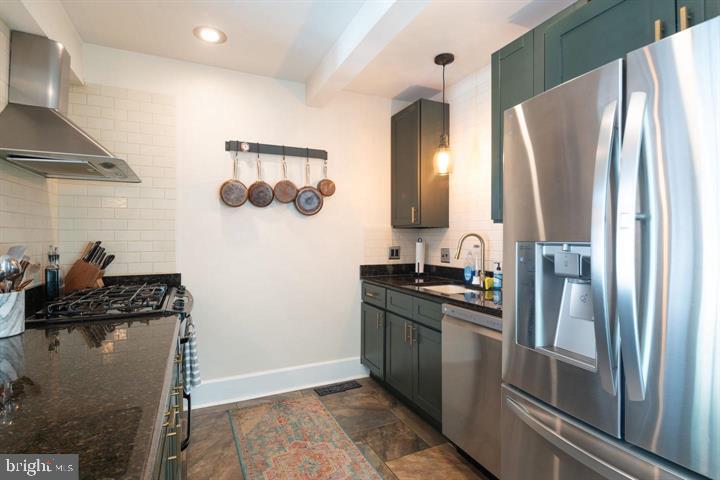 229 Benezet Street Philadelphia, PA 19118 - Photo 9 of 31 a kitchen with stainless steel appliances granite countertop a refrigerator and a sink
