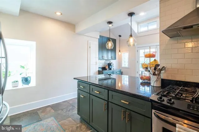 a kitchen with stainless steel appliances granite countertop a sink stove and cabinets