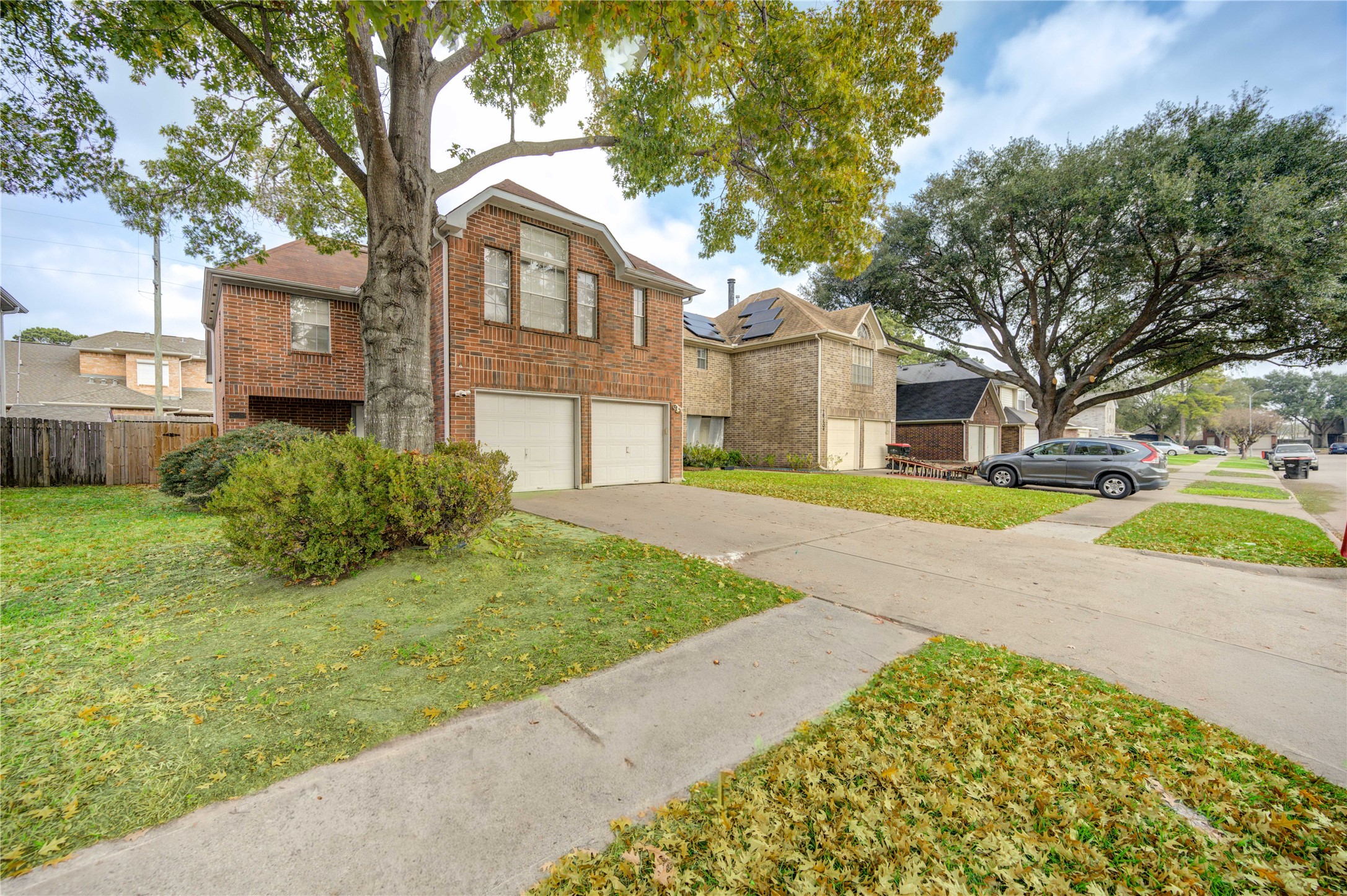 10338 Timberloch Drive Houston, TX 77070 - Photo 2 of 22 a yellow house with trees in front of it