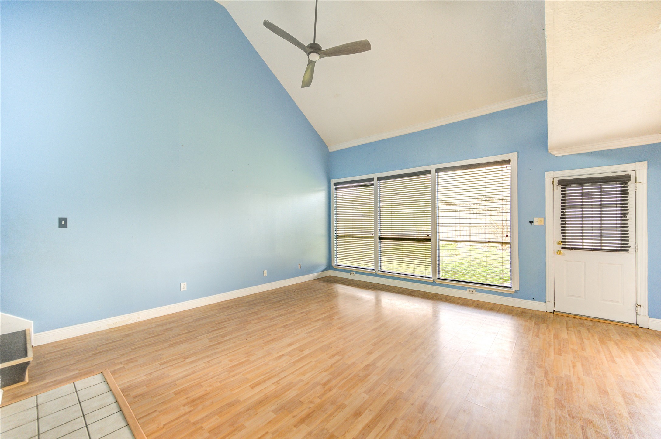 10338 Timberloch Drive Houston, TX 77070 - Photo 4 of 22 a view of an empty room with wooden floor and a window