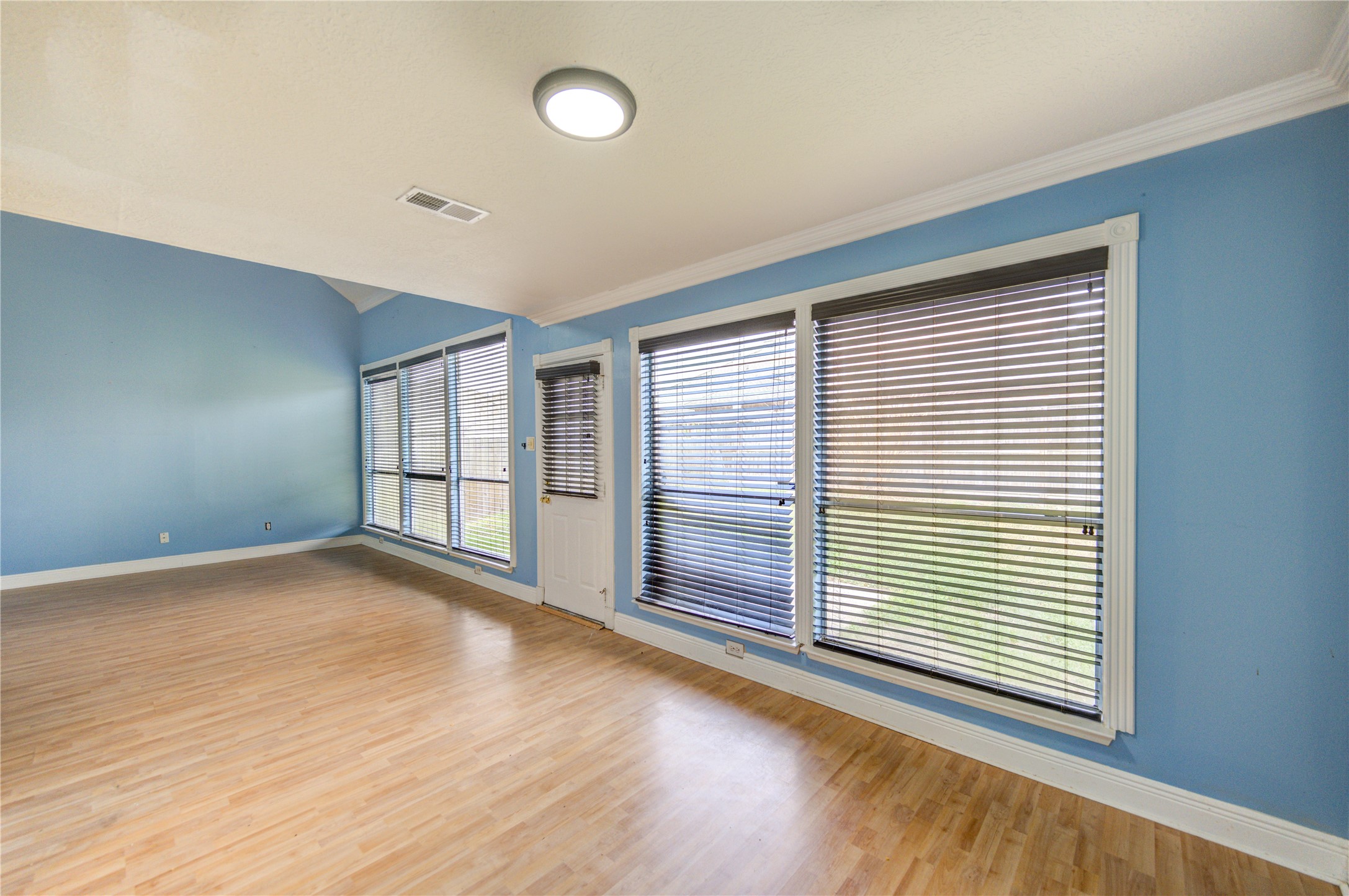 10338 Timberloch Drive Houston, TX 77070 - Photo 6 of 22 a view of an empty room with wooden floor and a window