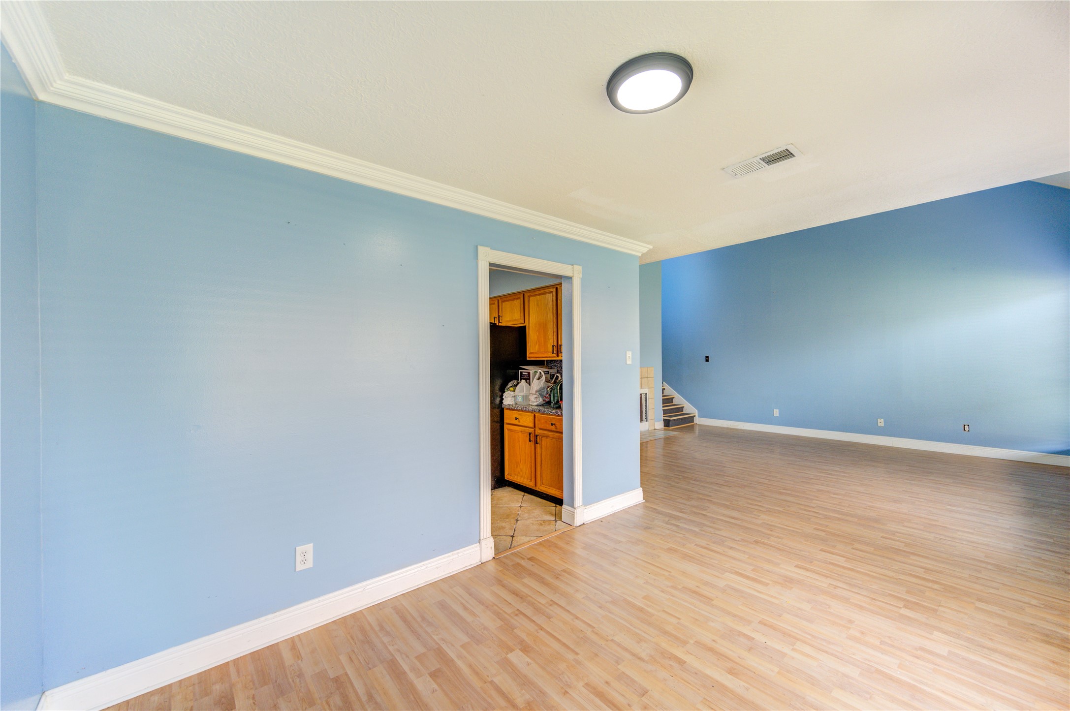10338 Timberloch Drive Houston, TX 77070 - Photo 7 of 22 a view of an empty room with wooden floor and a window