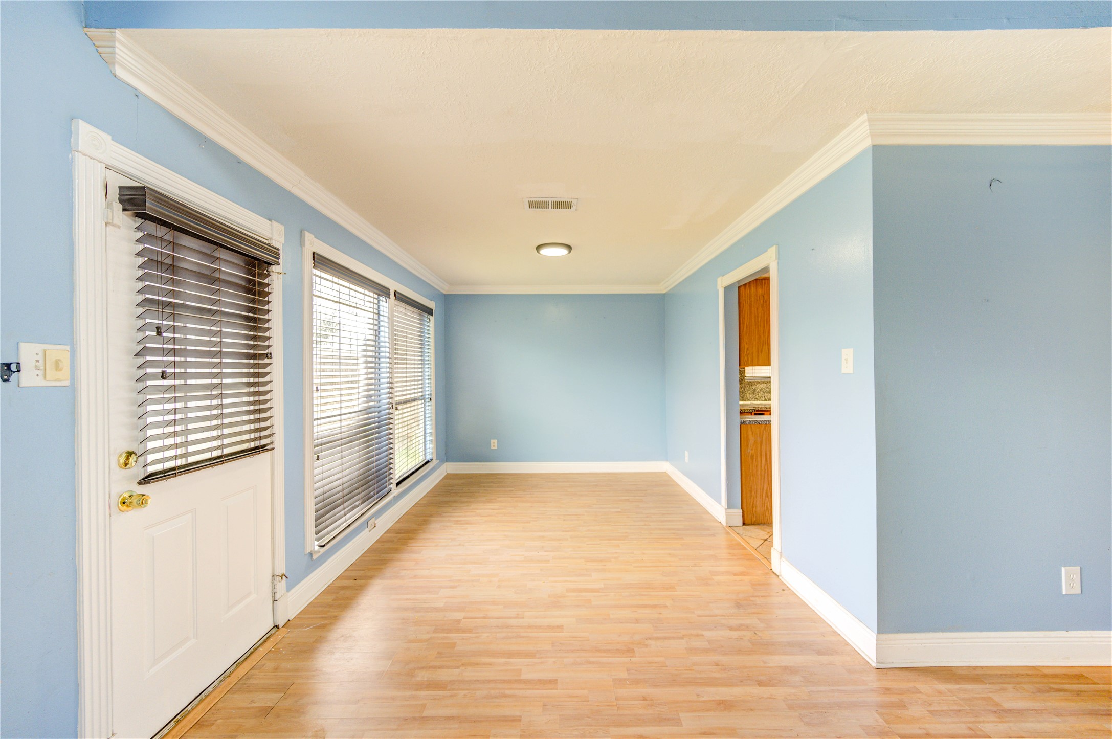 10338 Timberloch Drive Houston, TX 77070 - Photo 8 of 22 a view of an empty room with wooden floor and a window