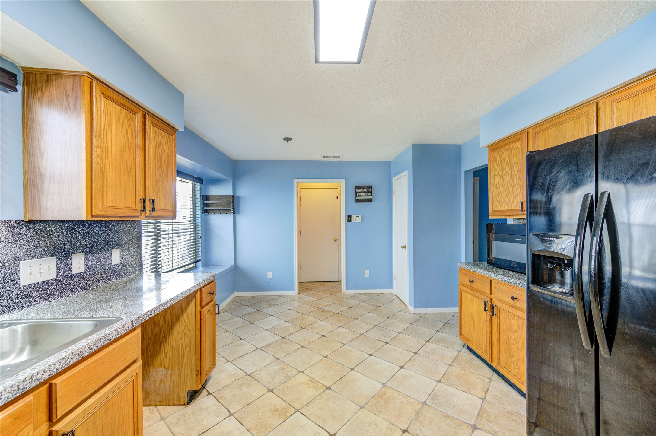 10338 Timberloch Drive Houston, TX 77070 - Photo 10 of 22 a kitchen with stainless steel appliances granite countertop a sink a stove and a refrigerator