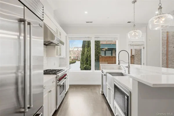 a kitchen with stainless steel appliances a sink stove and refrigerator