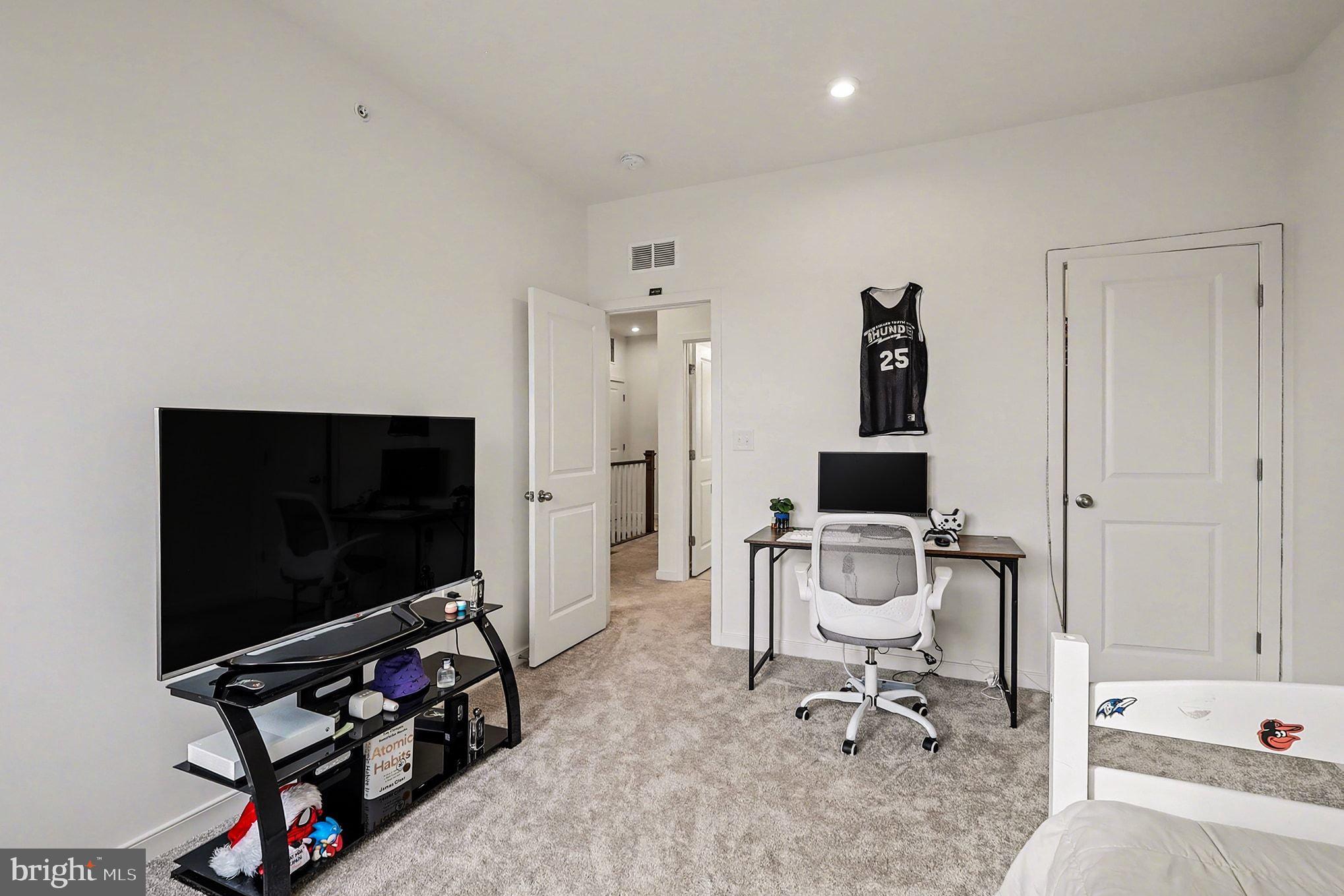 45956 Swallow Terrace Sterling, VA 20165 - Photo 16 of 29 a living room with furniture and a flat screen tv