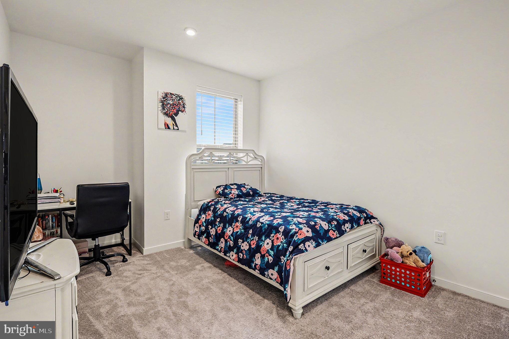 45956 Swallow Terrace Sterling, VA 20165 - Photo 17 of 29 a bedroom with a bed and a chair