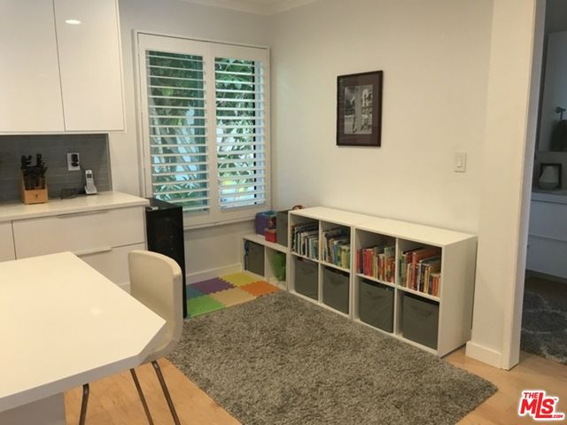a living room with a large window and a flat screen tv