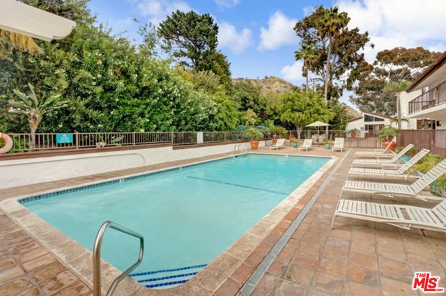 a view of a swimming pool with an outdoor space and seating area