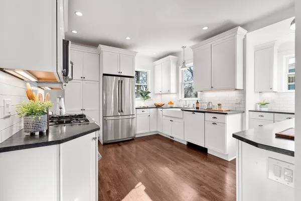 a kitchen with a sink stove and refrigerator
