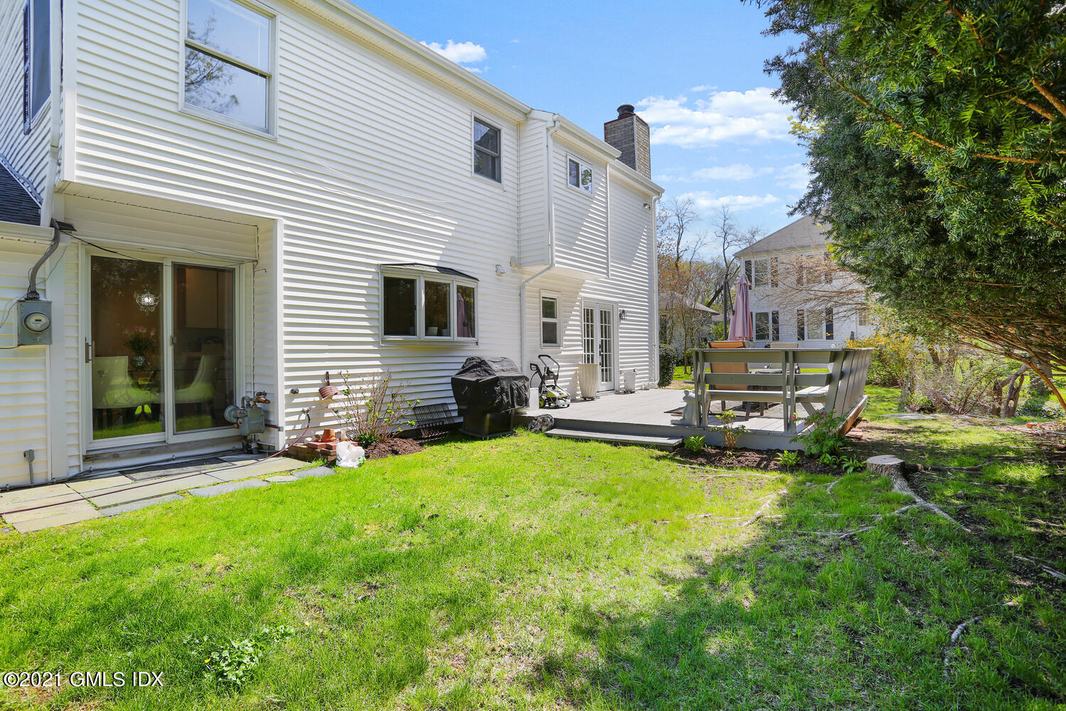 39 Sunshine Avenue Riverside, CT 06878 - Photo 29 of 34 a view of a house with patio next to a yard