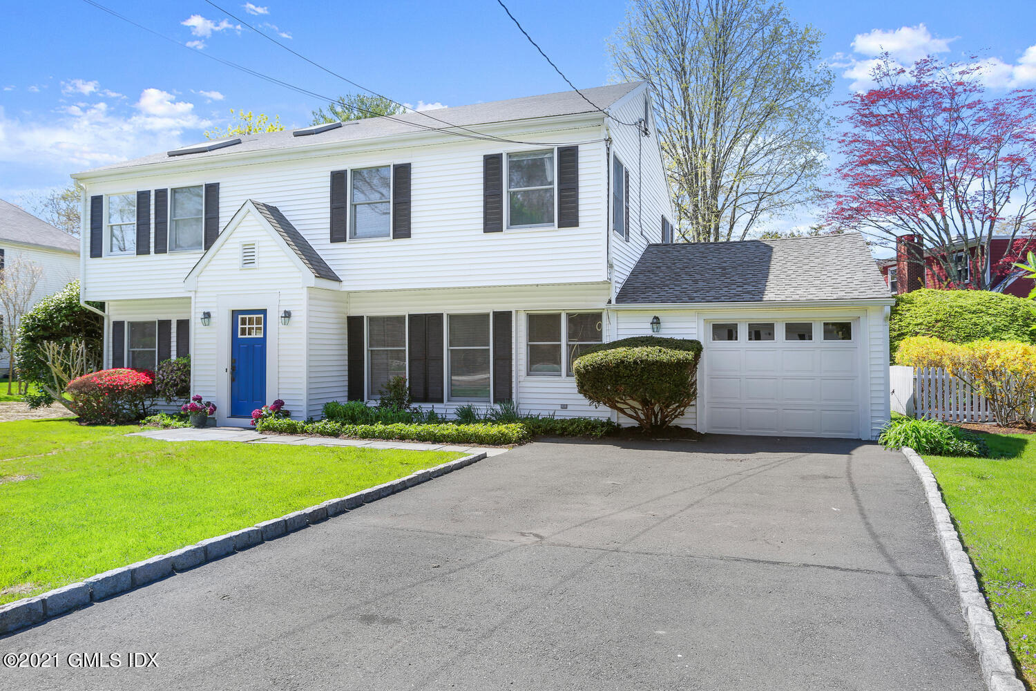 39 Sunshine Avenue Riverside, CT 06878 - Photo 31 of 34 a front view of a house with a yard and garage