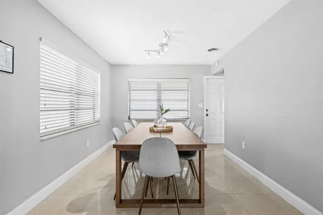 a view of a dining room with furniture and window