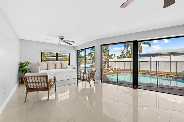 a dining room with furniture and large windows