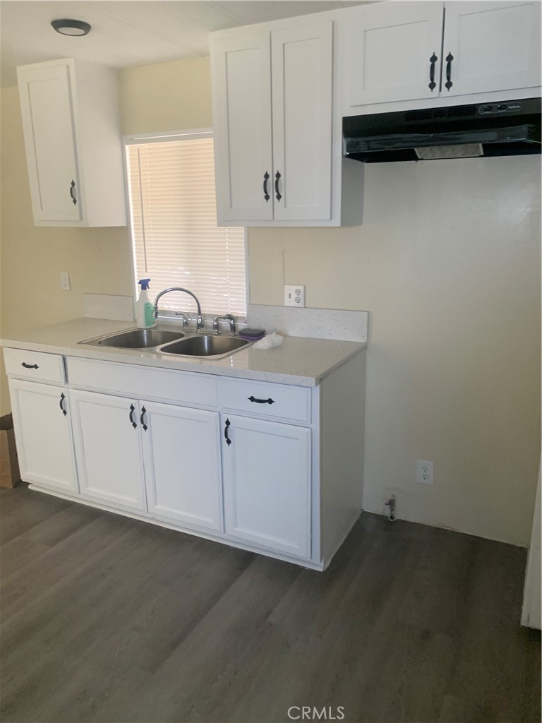 2865 West Rialto Avenue, Unit 2 Rialto, CA 92376 - Photo 7 of 19 a kitchen with granite countertop white cabinets and a sink