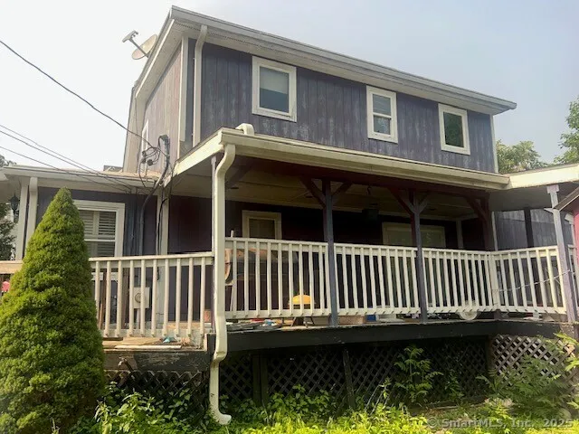 a view of a house with a small yard and wooden fence
