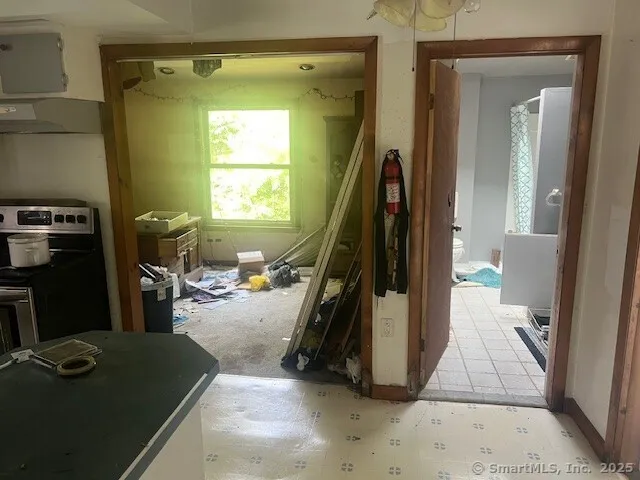 a living room with a bed furniture and a window