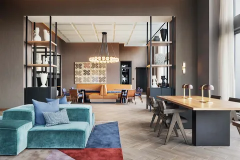 a living room with furniture a chandelier and a large window