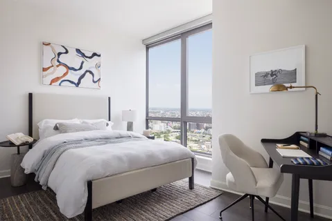 a bedroom with a bed and a window