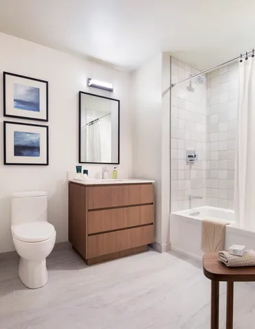 a bathroom with a sink a toilet and a mirror