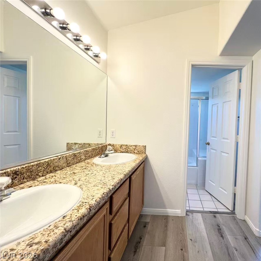 8284 West Rochelle Avenue Las Vegas, NV 89147 - Photo 15 of 29 Double vanity with stone counters provides ample space in this well-appointed bathroom.
