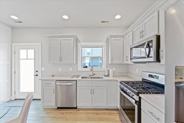 a kitchen with a sink stove and cabinets