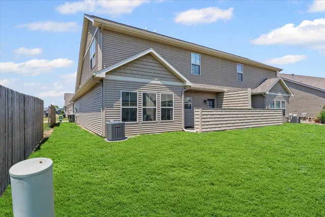 a view of a house with a yard and a garden