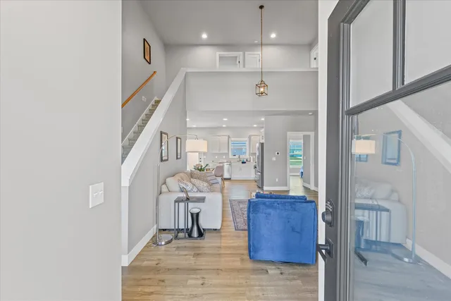 a view of a living room with furniture and wooden floor