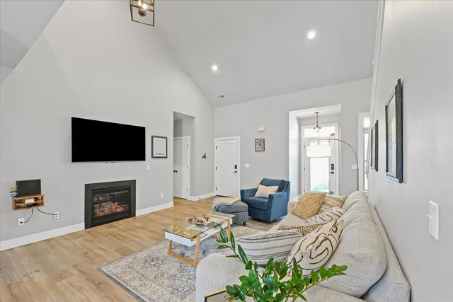 a living room with furniture a flat screen tv and a fireplace