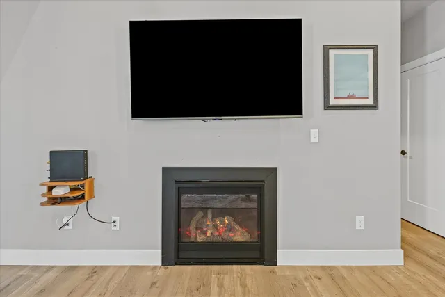 a living room with a fireplace and a flat screen tv
