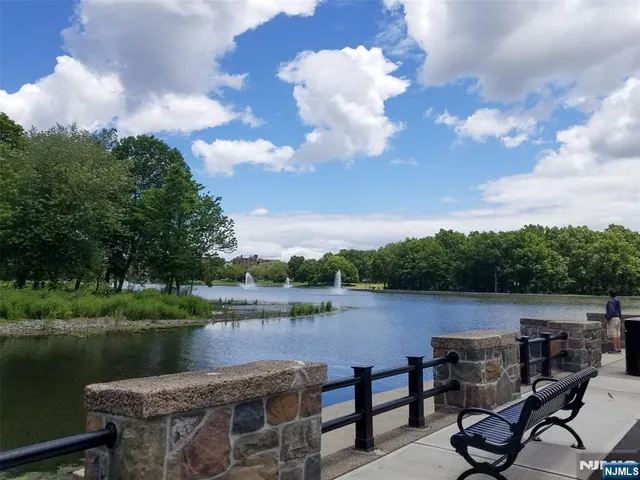a view of a lake with a table and chairs