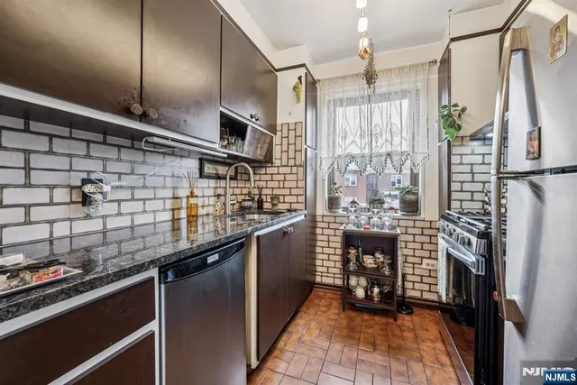 a kitchen with refrigerator and cabinets