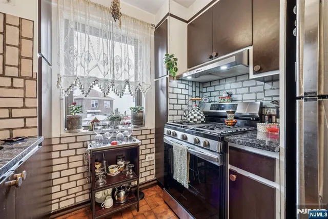a kitchen with stainless steel appliances granite countertop a stove and a sink