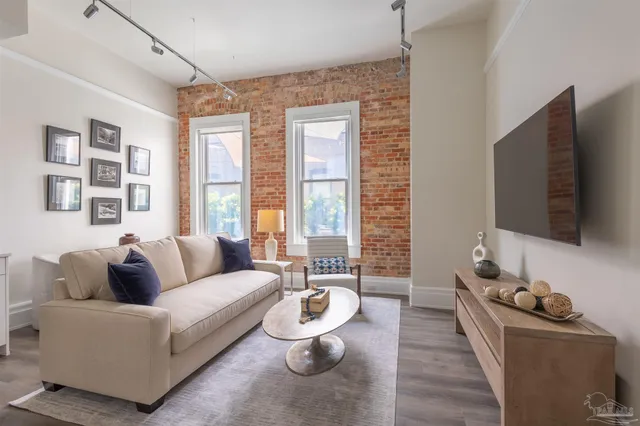 a living room with furniture and a flat screen tv