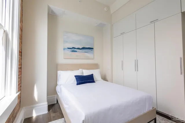 a bedroom with a bed and a window