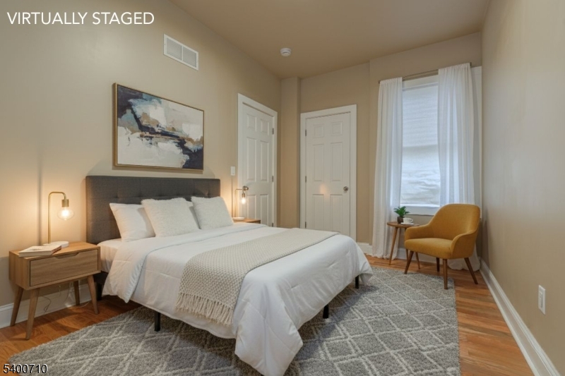 882 South 14th Street, Unit 1 Newark, NJ 07108 - Photo 4 of 17 a bedroom with a bed and a couch